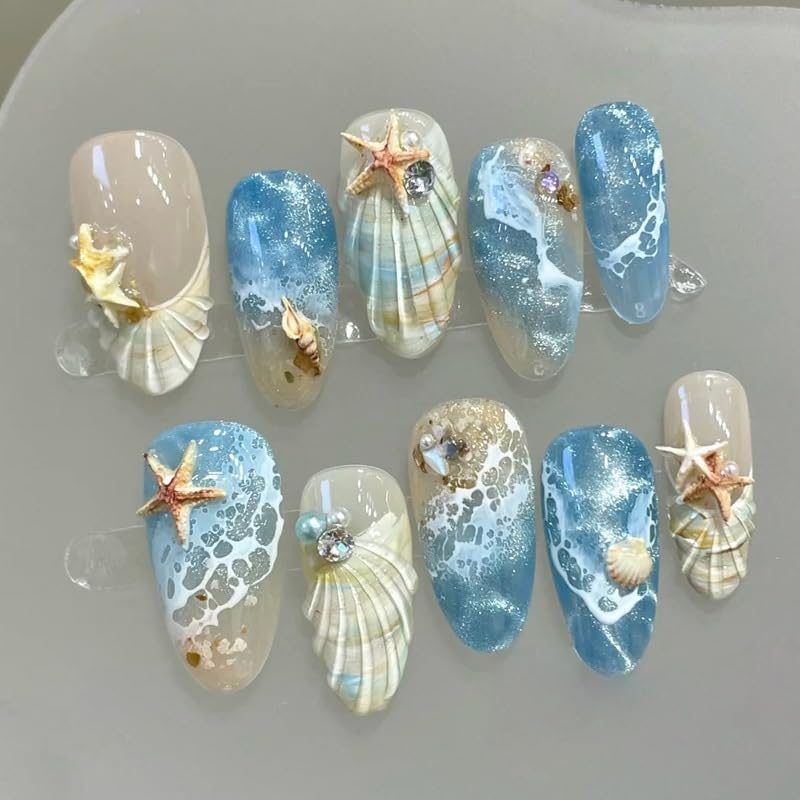 Blue seaside false nails, decorated false nails, seashell nail art, starfish nails, ocean-inspired nails, coastal nail designs, beach themed nails, Australian nail art