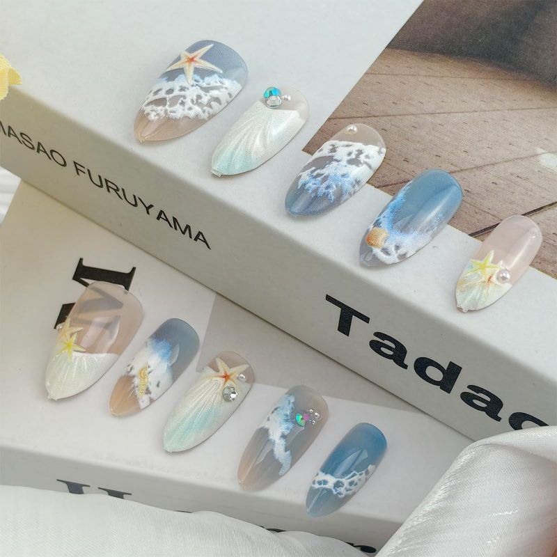 Blue seaside false nails, decorated false nails, seashell nail art, starfish nails, ocean-inspired nails, coastal nail designs, beach themed nails, Australian nail art