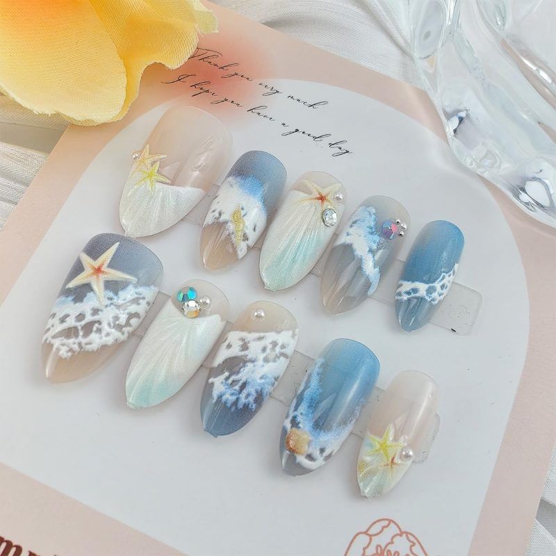 Blue seaside false nails, decorated false nails, seashell nail art, starfish nails, ocean-inspired nails, coastal nail designs, beach themed nails, Australian nail art