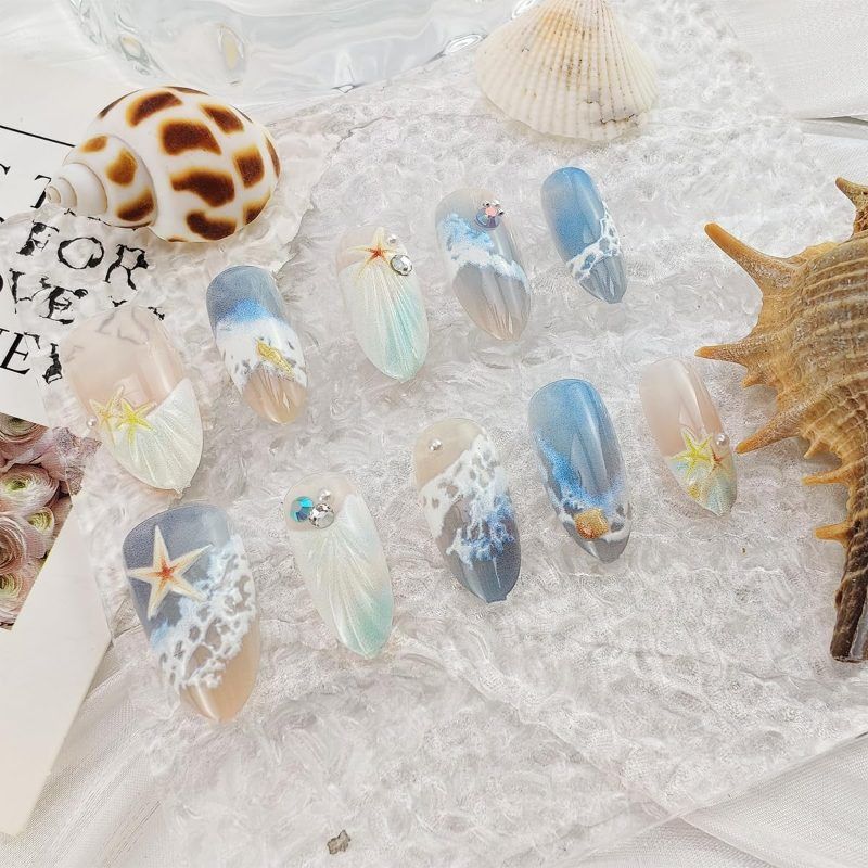 Blue seaside false nails, decorated false nails, seashell nail art, starfish nails, ocean-inspired nails, coastal nail designs, beach themed nails, Australian nail art